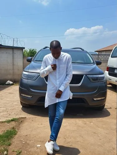 a man in a white shirt is standing next to a car,olamide,abaga,iyanya,lavage,kaduna,car loading,Photography,General,Realistic