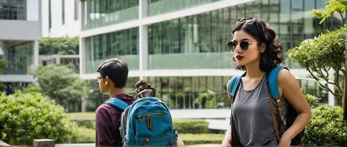 College of Arts and Architecture, modern building, glass facade, steel structure, sprawling campus, lush greenery, vibrant flowers, outdoor sculptures, students chatting, backpacks, laptops, notebooks