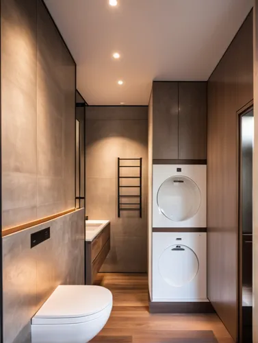 Bathroom in warm tones, concrete floor, decorative plaster walls imitating concrete, closet with a washing machine and dryer, wooden cabinet facade, installation, toilet, spot lighting on the ceiling.