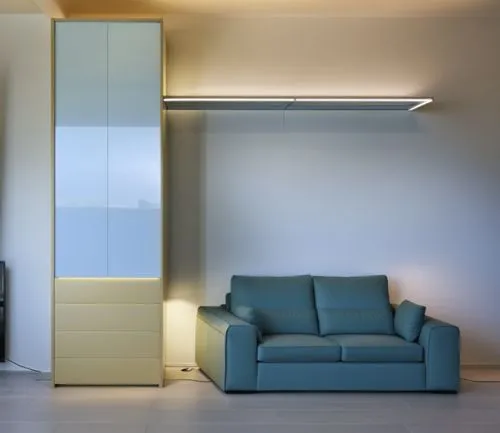 a large shelf above the sofa lights up with its large LED in a modern and warm style, the welcoming and soft sofa matches the rest of the house perfectly and the wardrobe next to it has a very well-ma