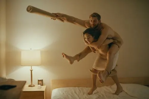 a naked woman is carrying a naked man on her back,man holds the body of his woman in the air as they are dancing on a bed,abramovic,pilobolus,borgman,two meters,piledriver,homography,Photography,Docum