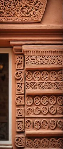 Architectural decorative clay products, intricate ceramic details, earthy tone, terracotta color, ornate patterns, geometric shapes, rustic texture, handmade craft, ancient inspiration, Mediterranean 