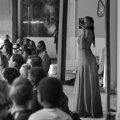 Beautyfull young african woman. Black and white. Watched by many spectators in a Fashion public show,girl in a long dress from the back,girl in a long dress,woman holding a smartphone,long dress,weddi