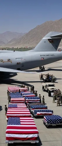 Pictured:Flag-draped coffins of service members killed in action are loaded onto a transport aircraft during a ramp ceremony at Hamid Karzai International Airport in Kabul, Afghanistan August 27, 2021