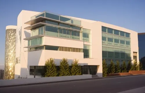 white tile, modern, multi-story, office building,  glass, and silver aluminum glazing, glass with reflections, midday, sunny, clouds, major cityscape, surrounded by other buildings, with multiple peop