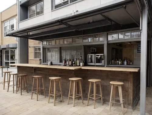 add a small kitchen and bar  to sell sandwiches and buy drinks for university students with some seating don't change the essential building  
,beer tables,bar stools,beer table sets,bar,bar stool,bee