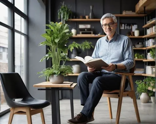 Peter Fawcett, male, middle-aged, bespectacled, grey hair, casual wear, holding architecture design notebook, pencil in hand, standing, modern minimalist interior, natural light pouring through floor-