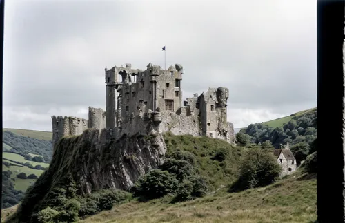 A ruined castle on a hillside in south-west England.,lubitel 2,ruined castle,castles,knight's castle,castel,medieval castle,castle,castle of the corvin,castle bran,ghost castle,castle ruins,camelot,ha