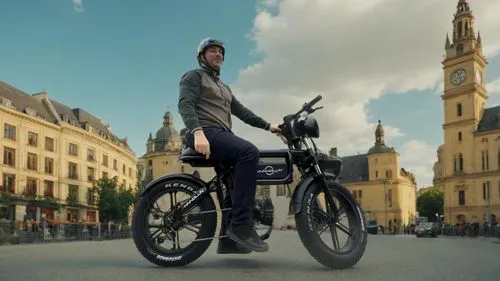 Dynamic urban adventure on European streets, stylish riding through a modern city under a bright blue sky in the daytime.,man sitting on the seat of a motorcycle in front of some buildings,velib,photo