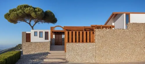 esta hecho de sillar blanco y de ladrillo caravista   con un arbol cercano a la entrada con un muro de piedra,dunes house,casabella,fresnaye,cubic house,vivienda,corten steel,renders,costabile,stucco 