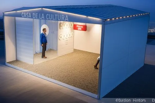 the man is walking through a white booth,shelterbox,cubic house,shipping container,sales booth,cube house,creative office,smartsuite,jetway,containerized,modern office,electrohome,snowhotel,prefabrica