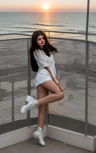 a portrait full body of a  beautiful Selena Gomez 25 years old, black hair red lips wearing a white blouse and black shorts, black boots stand up in a leg in a balcony at sunset whit a modern building