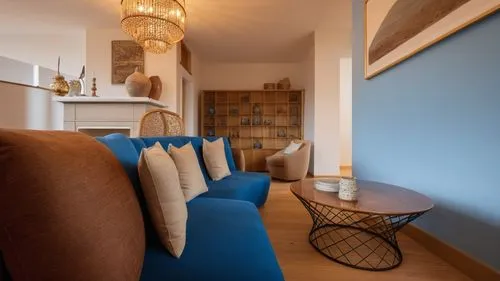 a blue couch and a table in a room,inverted cottage,contemporary decor,home interior,showhouse,blue room,appartement,interior decor,lettings,vicarage,interior decoration,sitting room,search interior s