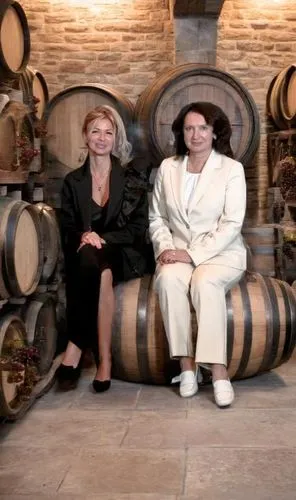 two women sitting on top of wooden barrels,wine barrel,wine barrels,abfab,aterciopelados,two types of wine,bastianich