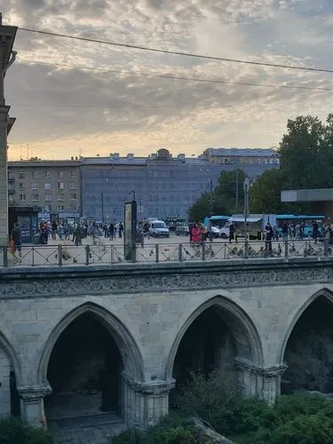 средневековье,a person is walking on an overpass over some plants,pont d'avignon,tiber bridge,angel bridge,sant'angelo bridge,tblisi,skopje