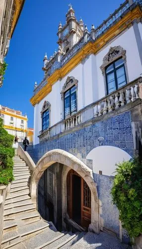 Historic Portuguese architecture, Manueline style, ornate stone carvings, intricate balconies, grandiose entrance, azulejo tiles, white limestone walls, rusted rooftops, Baroque details, Gothic influe