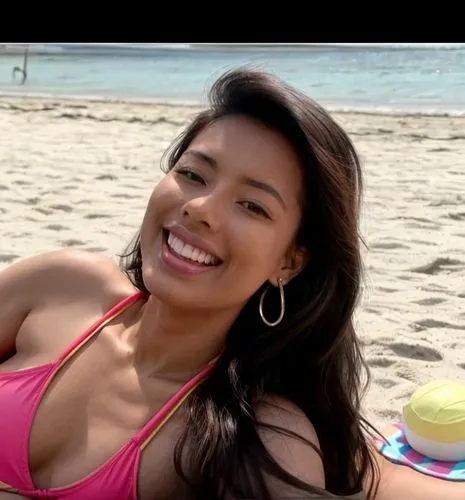 She is sunbathing on the beach.  wearing a colorful swimsuit.  She is lying on the beach and laughing.,guelaguetza,mugdha,taraji,filipina,marshallese,irigoyen,filipino,santana,amerie,beach background,