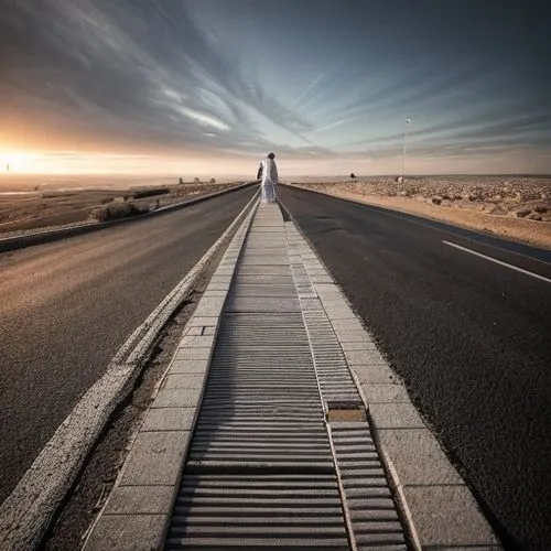 Male Muslim walking on a 3 way crossroad ,road to nowhere,road of the impossible,vanishing point,long road,straight ahead,the road to the sea,empty road,the road,sand road,the way,road to success,open