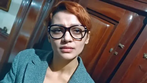 a woman with glasses in front of wooden cabinets,zoabi,pragya,bhimanto,gyanendra,secretarial,danaus,Photography,General,Realistic