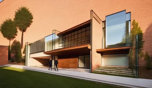 two men walking out of a building by a grass covered slope,corten steel,adjaye,esade,fondazione,bicocca,institucion,school design,athens art school,instituto,biotechnology research institute,csulb,mod