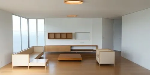 hay un televisor en la pared del fonto y los muebles aereos son de madera,las 2 lamparas de techo son redondas luz blanca,a room with white walls, wooden floors and tables,anastassiades,minotti,modern