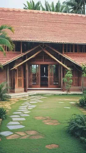 a symmetrical pitched roof kerala house, central entance with main door, either sides big glazed window, with front portion a pitched roof and either side higher roof pitched.  roof with mangalore til