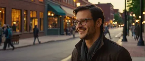 Modern architectural lighting designer, male, 30s, casual wear, glasses, short hair, smiling, Ann Arbor, Michigan, downtown area, evening time, warm golden lighting, urban cityscape, brick buildings, 