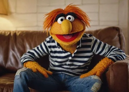 Muppet, solo, (adult), unibrow, bright brown eyes, pale skin, messy orange hair, casual wear, striped shirt, blue jeans, sneakers, sitting, couch, living room, warm lighting, cozy atmosphere, comedic 