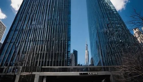 Modern skyscraper, AIA headquarters, daytime, clear blue sky, sleek glass façade, angular lines, steel beams, grand entrance, revolving doors, marble lobby, elegant chandeliers, busy streets, urban la