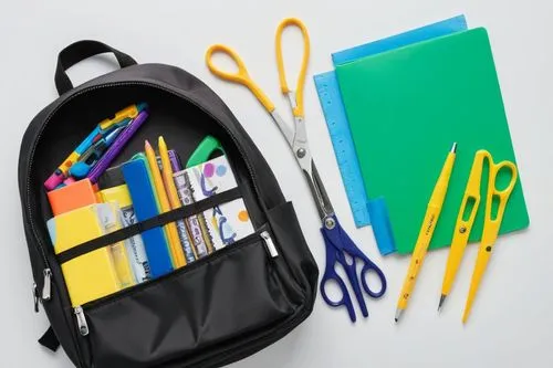 school supplies are packed into a backpack on a table,school items,back-to-school package,bookbags,schoolbags,school tools,school pencil case