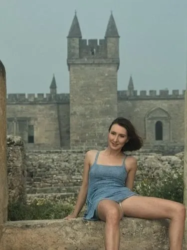 man and woman posing in front of an ancient building,a woman is sitting outside and posing for the camera,iulia hasdeu castle,shipka,gal,isinbayeva,girl in a historic way,letizia,Photography,Black and