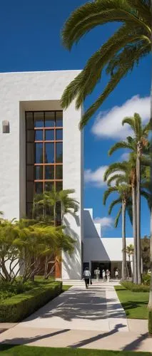 Santa Barbara CA, architecture museum, modern building, white exterior walls, large glass windows, minimalist entrance, wooden doors, abstract sculptures, outdoor fountain, surrounding lush greenery, 