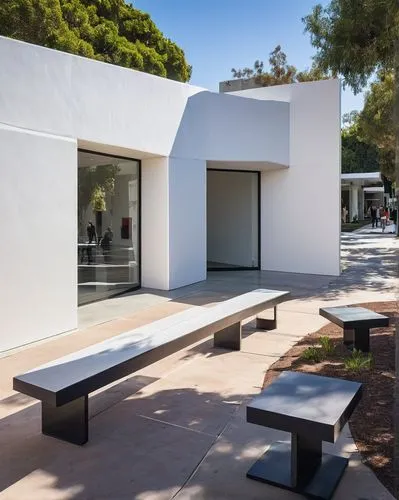 Culver City Museum of Design Art and Architecture, modern building, white exterior walls, glass windows, geometric shapes, minimalist design, spacious interior, high ceilings, wooden floors, natural l