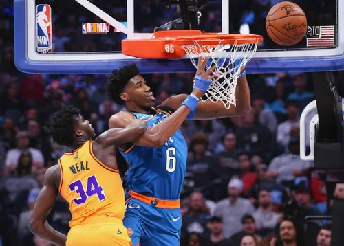 Hamidou Diallo #6 of the Oklahoma City Thunder dunks over Shaquille O'Neal during the AT&T Slam Dunk as part of the 2019 NBA All-Star Weekend at Spectrum Center on February 16, 2019 in Charlotte, Nort