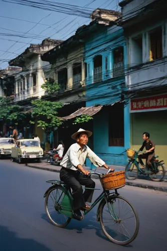 A man cycles on a street in Hanoi in this photo taken by German photographer Thomas Billhardt during the 1970s.,hanoi,ha noi,vietnam vnd,vietnam,ho chi minh,hoian,saigon,viet nam,rickshaw,vietnam's,ka