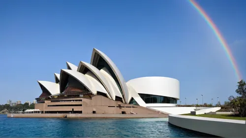 a modern architecture, fish shape,  white exterior, curved lines, consistent style, rainbow,opera house sydney,sydney opera house,sydney opera,opera house,australia aud,semper opera house,lotus temple