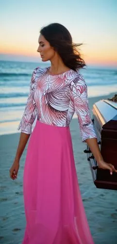 A WOMEN WEARING A DRESS WALKING ON THE BEACH AT THE SUNSET WEARING A CASKET,a woman with long hair and pink dress on the beach,scherzinger,kareena,angham,ivete,flamenca,sherine