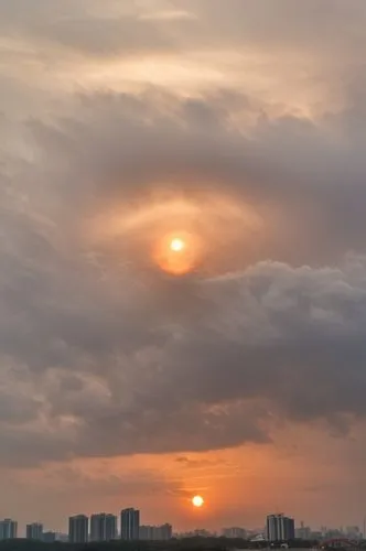 The sky features a giant cloud shaped like an eyeball, with the sun positioned at its center. time of the dust,sun in the clouds,sun through the clouds,chinese clouds,aso kumamoto sunrise,kaohsiung,da