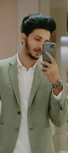 background whole mirror photos ,young man dressed in green jacket looking down at his phone,shivdasani,kurta,fardeen,randhir,sherwani,parupalli,raghav,shahid,majnu,sooraj,sahir,rizvi,sidharth,junaid,v