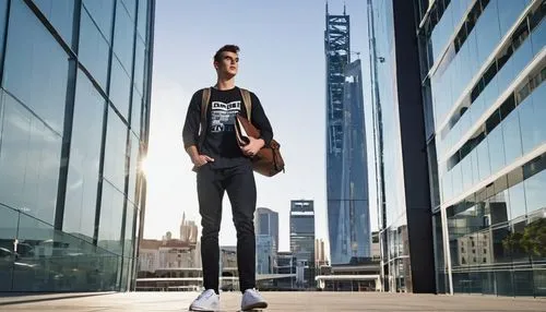 RMIT University, advanced diploma of architectural design, male student, 20s, casual wear, denim jeans, black graphic t-shirt, sneakers, backpack, holding a large portfolio, standing in front of a mod