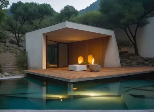 The sleek and minimalist interior of a minimalist cabin is illuminated by the soft, yellow light of a moonlit lake surrounded by dense concrete walls. A wooden walkway extends out towards a serene lak