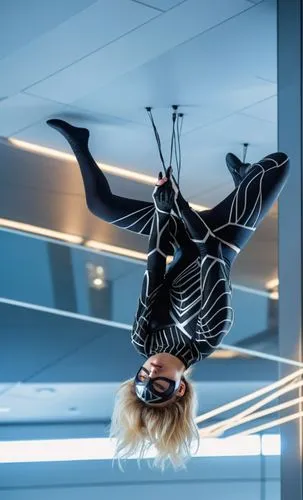 a photography of a beautiful caucasian blonde girl 22 years old, she is wearing a black mask and a black and white suit of spider woman of Marvel, she is head stop holding whit your hands some cables 