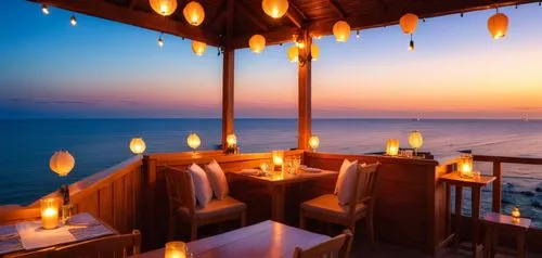 Here's the seaside restaurant during sunset with a warm, cozy ambiance and an open-air design, perfect for an evening by the ocean. The soft glow of the sunset and lanterns creates a peaceful and invi