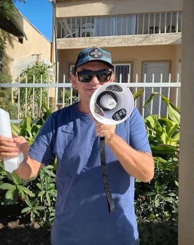 handheld electric megaphone,electric megaphone,trainer with dolphin,megaphone,vuvuzela,holding a coconut,hotel man,bullhorn,free reed aerophone,ko olina resort,coffee donation,local trumpet,water winn