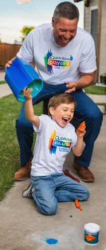 A boy and his father are laughing about the son's crayon-stained shirt. The father is kneeling in front of the QuickDrive™, holding out a fresh and clean white t-shirt that just came out of the wash f