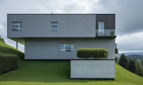 modern villa on the slope with diffrent trees in landscape & cloudy and gray sky ,cubic house,cube house,modern architecture,modern house,eisenman,house shape,frame house,arhitecture,residential house