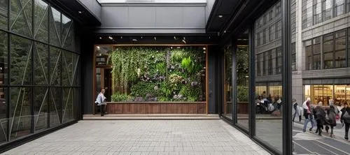 Coffee shop The front façade contains grass and glass in the right and left facades The left side of the picture Glass overlooking the mall from the inside and the right side of the picture Glass over