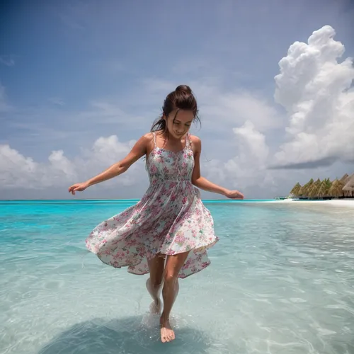 She is in a floral beach dress, in the Maldives, splashing water with her feet.,cook islands,skimboarding,little girl twirling,micronesia,walk on the beach,maldive islands,lifou,saona,maldivian,maldiv