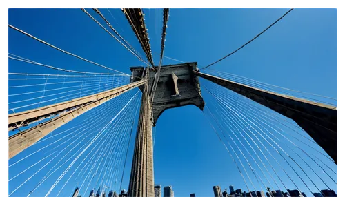 Brooklyn Bridge, NYC landmark, steel cable suspension, Gothic-style towers, majestic architecture, cloudy blue sky, sunny day, dramatic shadows, low-angle shot, wide-angle lens, vibrant colors, high c