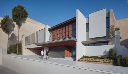 two people walking up a building made out of concrete,modern house,modern architecture,technion,exposed concrete,dunes house,contemporary,seidler,rehovot,mahdavi,tonelson,siza,corbu,residencia,givat,v